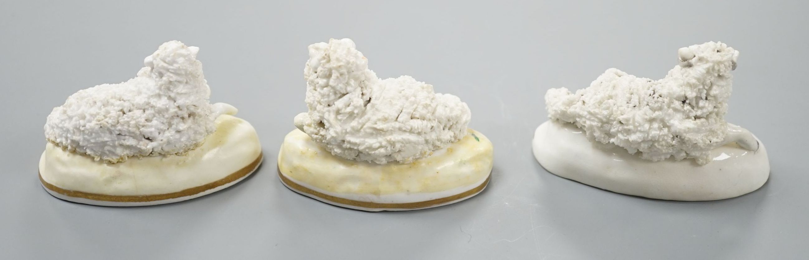 A pair of Samuel Alcock porcelain models of a ram and a ewe, d.1835–50, impressed mark ‘86’, largest 6.6 cm long together with a similar Staffordshire porcelain model of a ram (3), Provenance: Dennis G.Rice collection